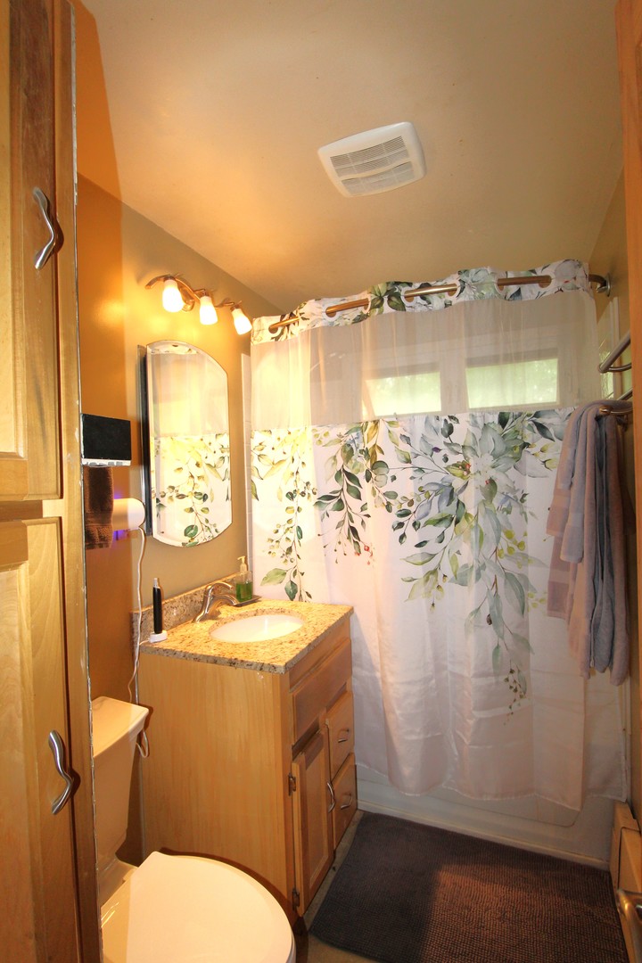 1843 North River Road Algonquin, IL 60102 - Photo 7 of 13 a bathroom with a sink mirror toilet and shower