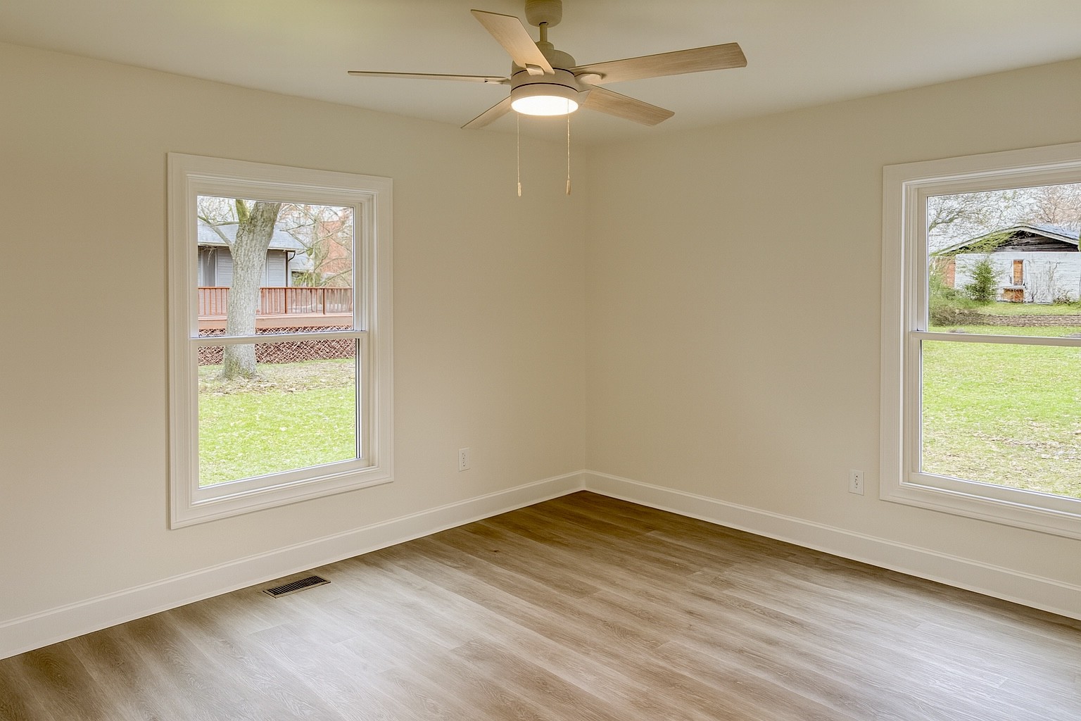 206 West Main Street Hohenwald, TN 38462 - Photo 15 of 24 a view of an empty room with wooden floor and a window