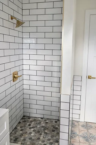 an empty room with wooden floor closet and windows