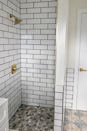 an empty room with wooden floor closet and windows
