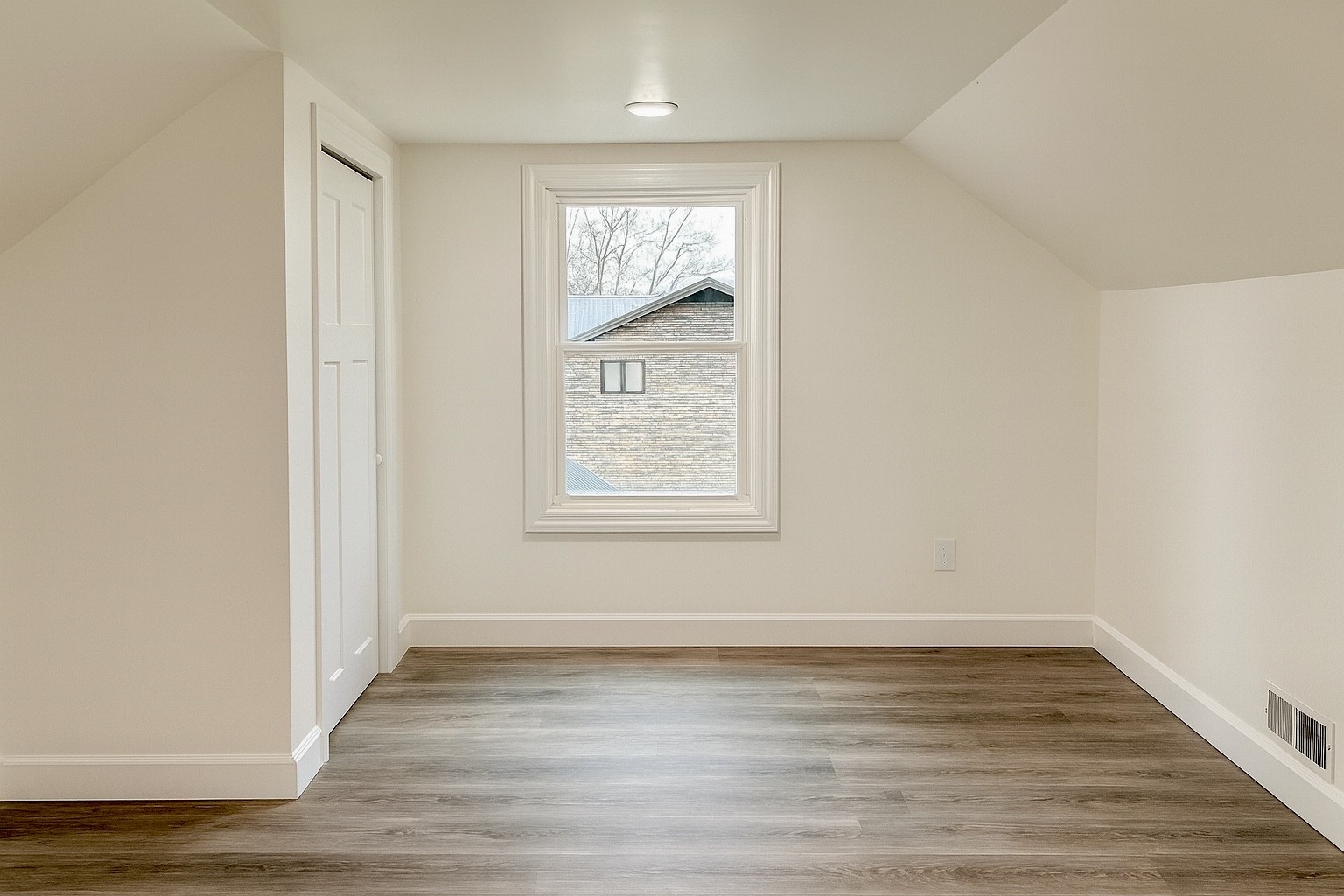 206 West Main Street Hohenwald, TN 38462 - Photo 21 of 24 an empty room with wooden floor and windows