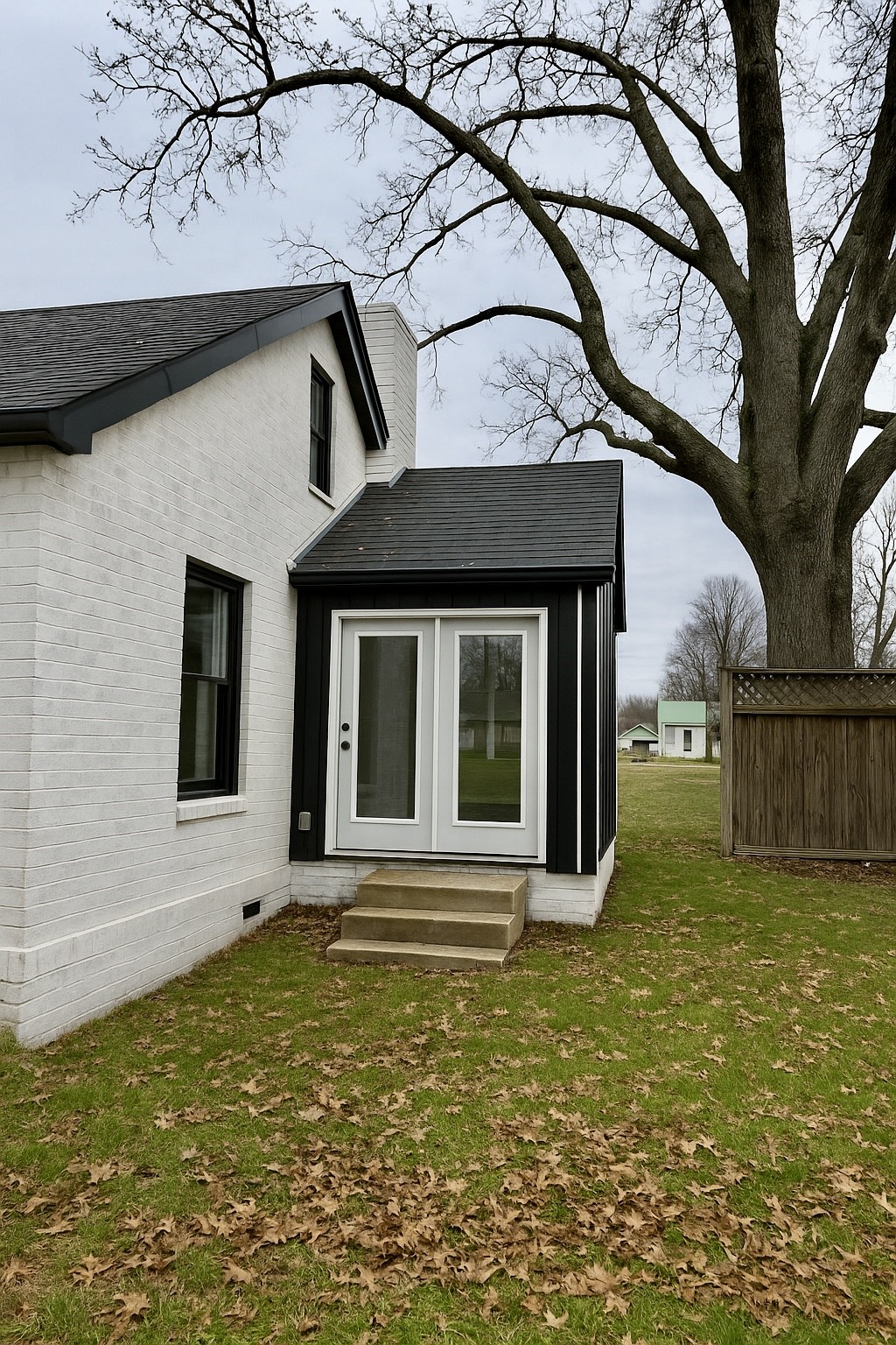 206 West Main Street Hohenwald, TN 38462 - Photo 3 of 24 a view of a house with a small yard and a large tree