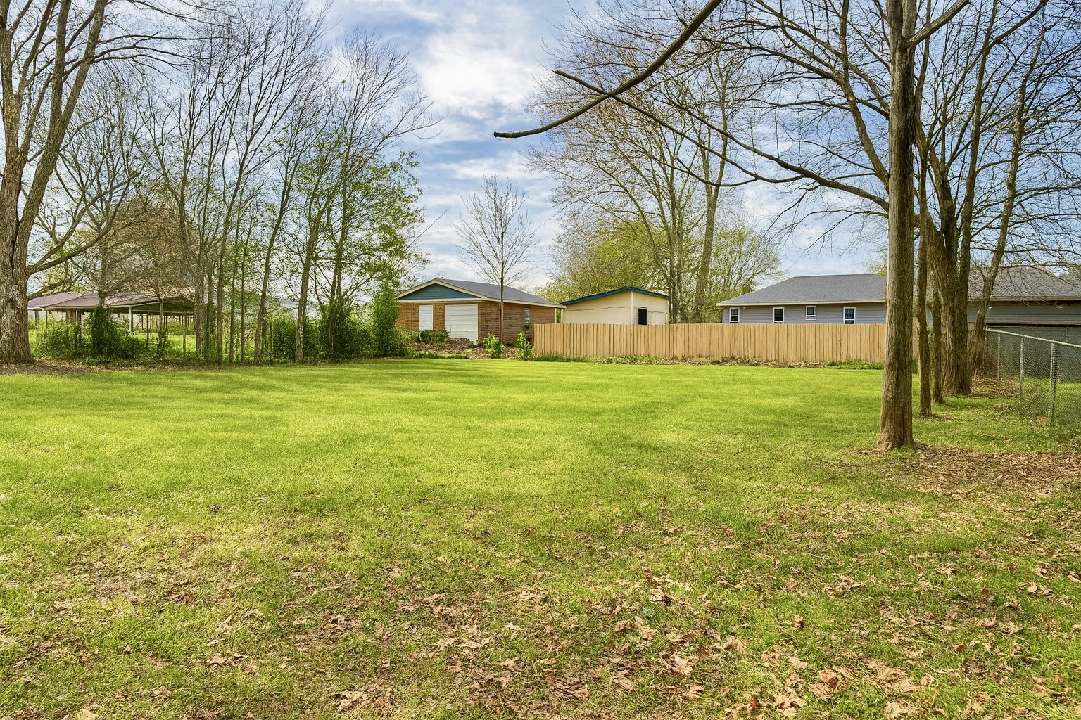 206 West Main Street Hohenwald, TN 38462 - Photo 7 of 24 a view of a yard with a house in the background