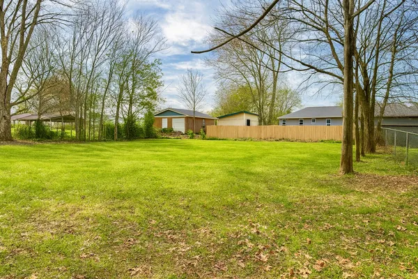 a view of a yard with a house in the background