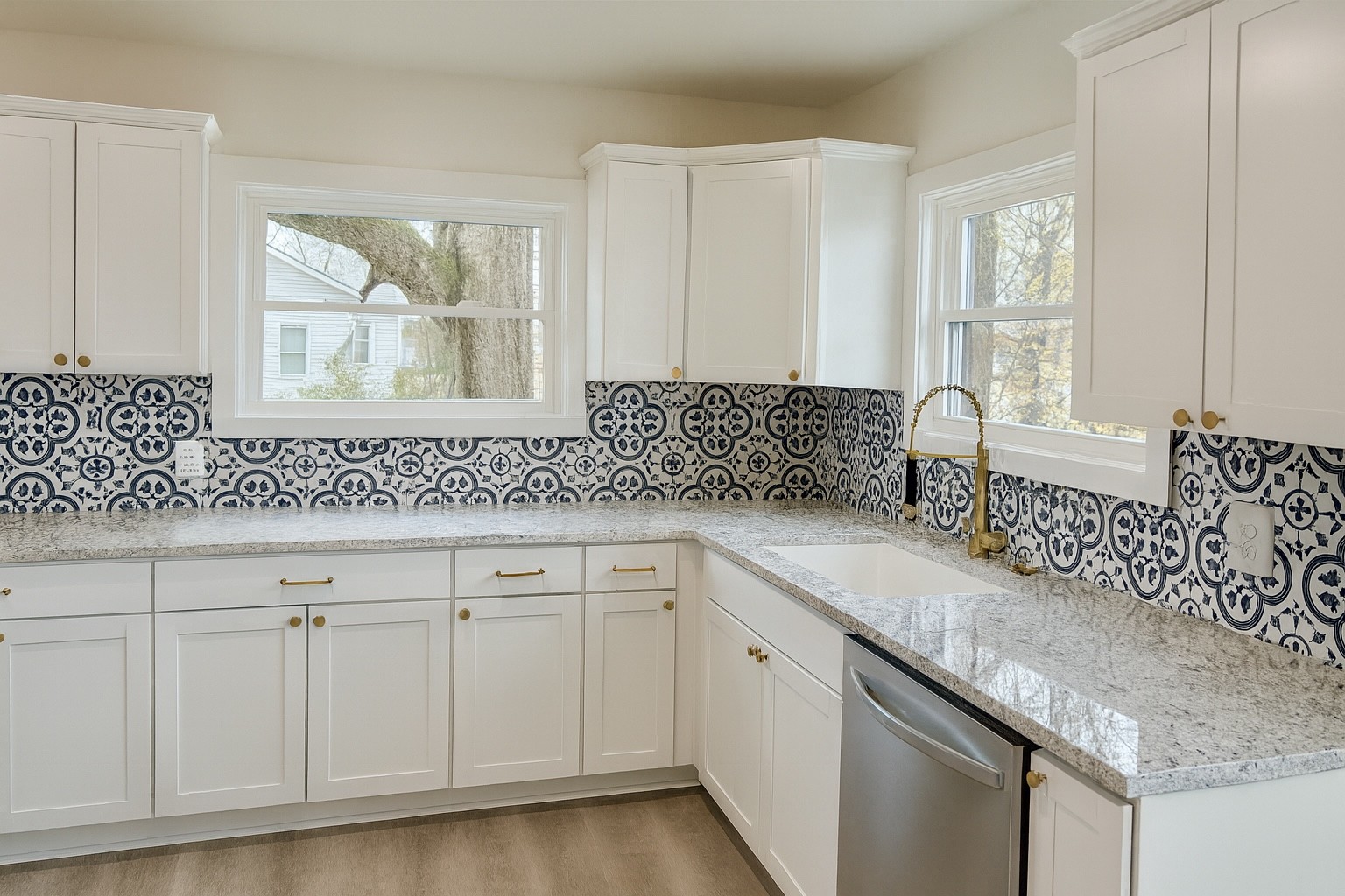 206 West Main Street Hohenwald, TN 38462 - Photo 10 of 24 a kitchen with granite countertop white cabinets and sink