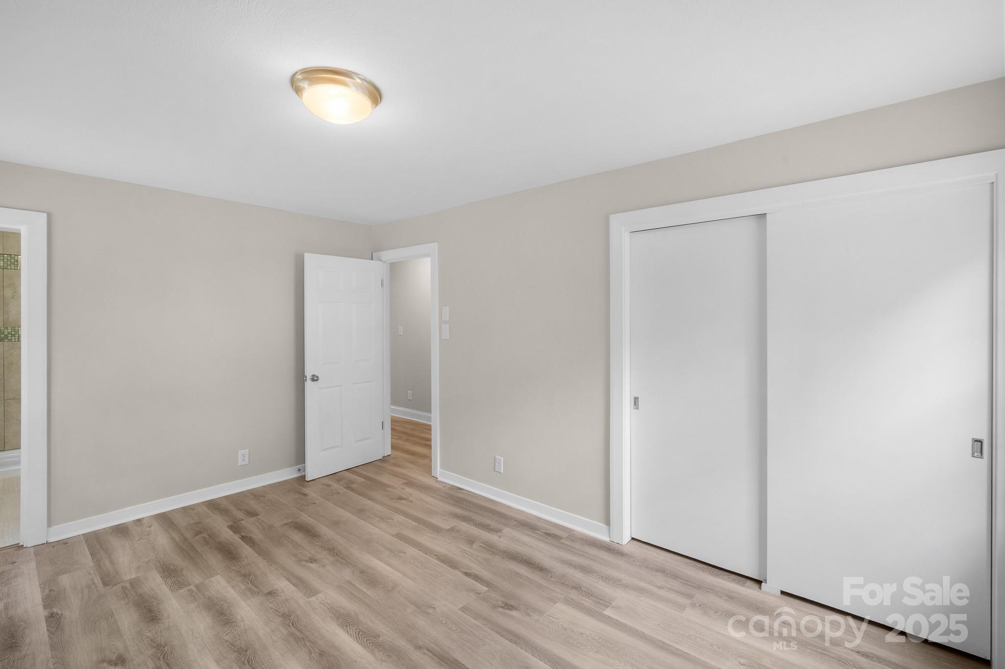 4355 Franklin Community Center Road Salisbury, NC 28144 - Photo 14 of 28 a view of an empty room with wooden floor and closet