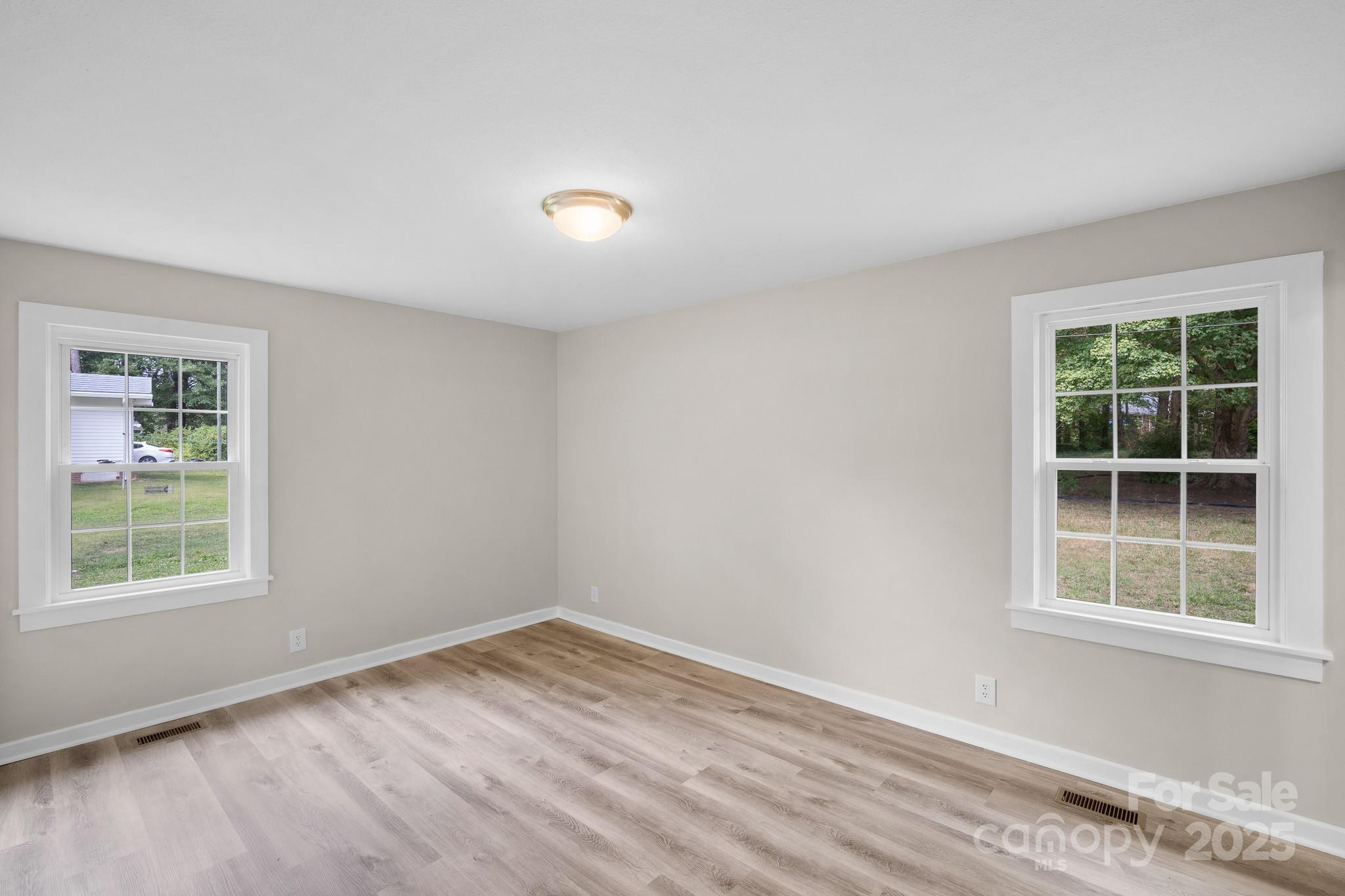 4355 Franklin Community Center Road Salisbury, NC 28144 - Photo 16 of 28 an empty room with wooden floor and windows