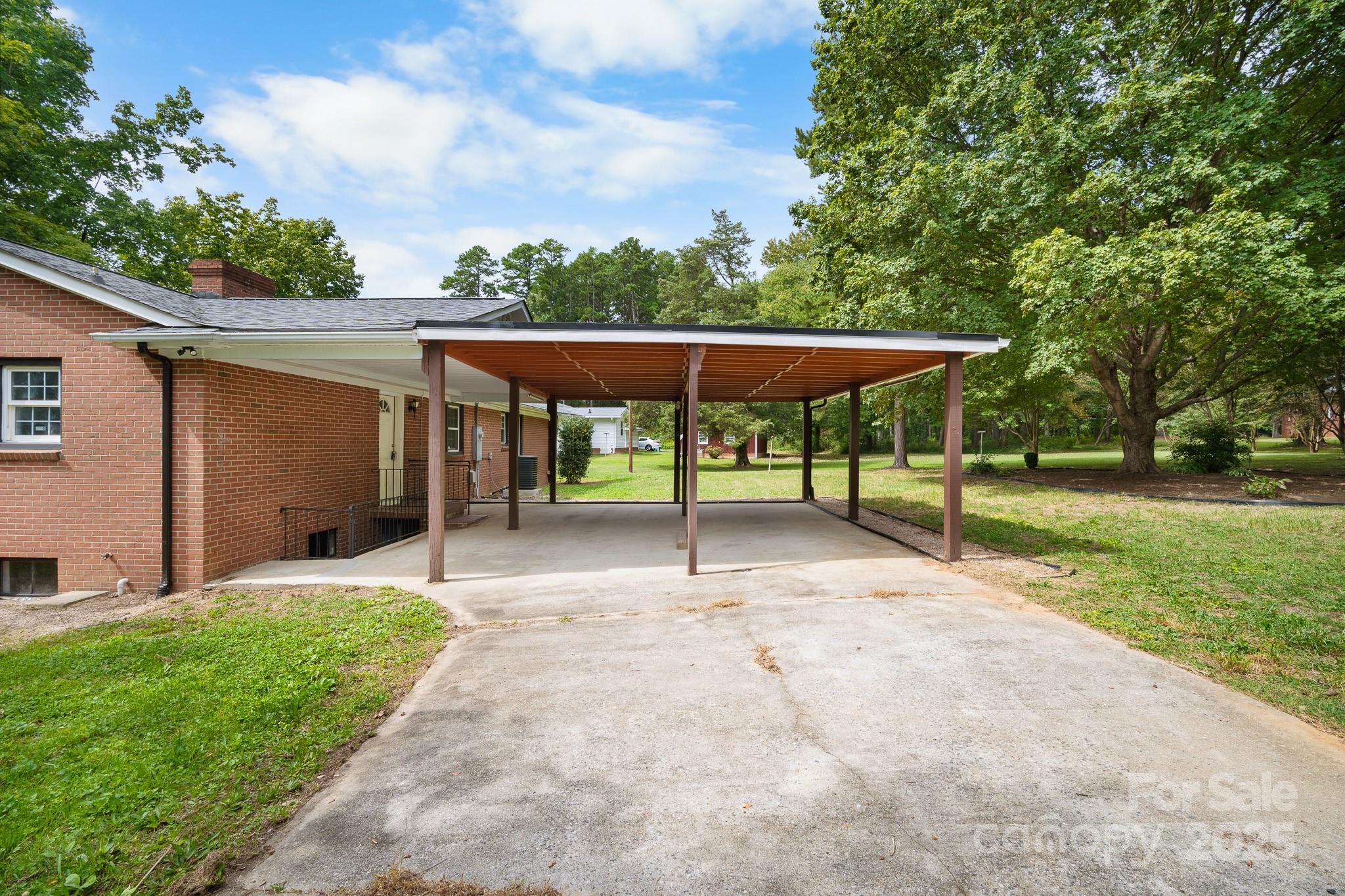 4355 Franklin Community Center Road Salisbury, NC 28144 - Photo 24 of 28 a view of a patio with a table and chairs under an umbrella