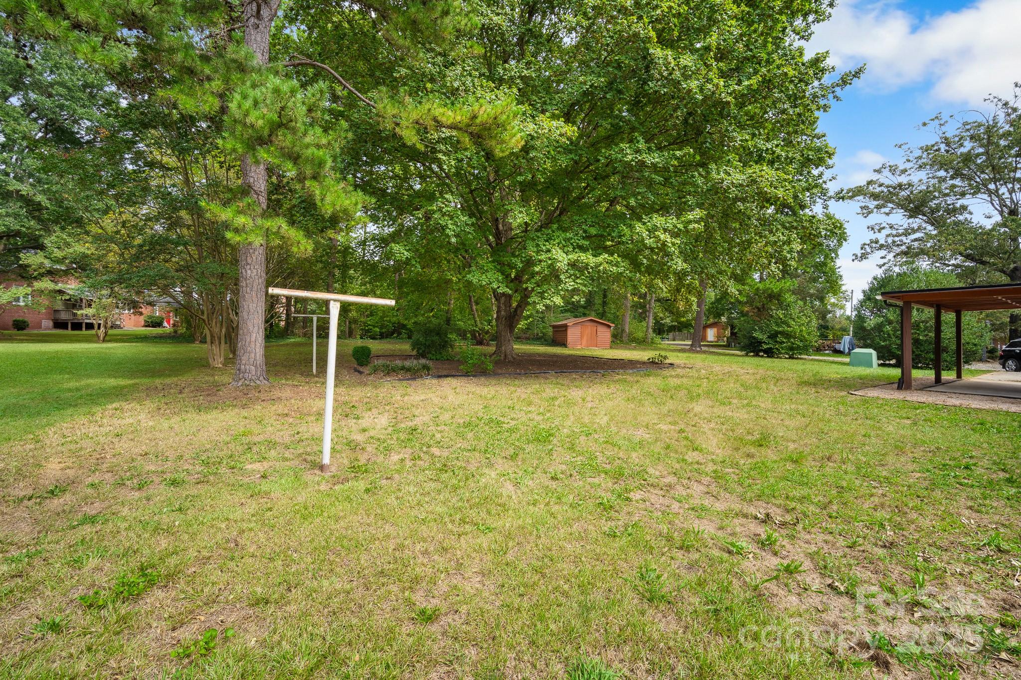 4355 Franklin Community Center Road Salisbury, NC 28144 - Photo 25 of 28 a view of a backyard with a garden and entertaining space