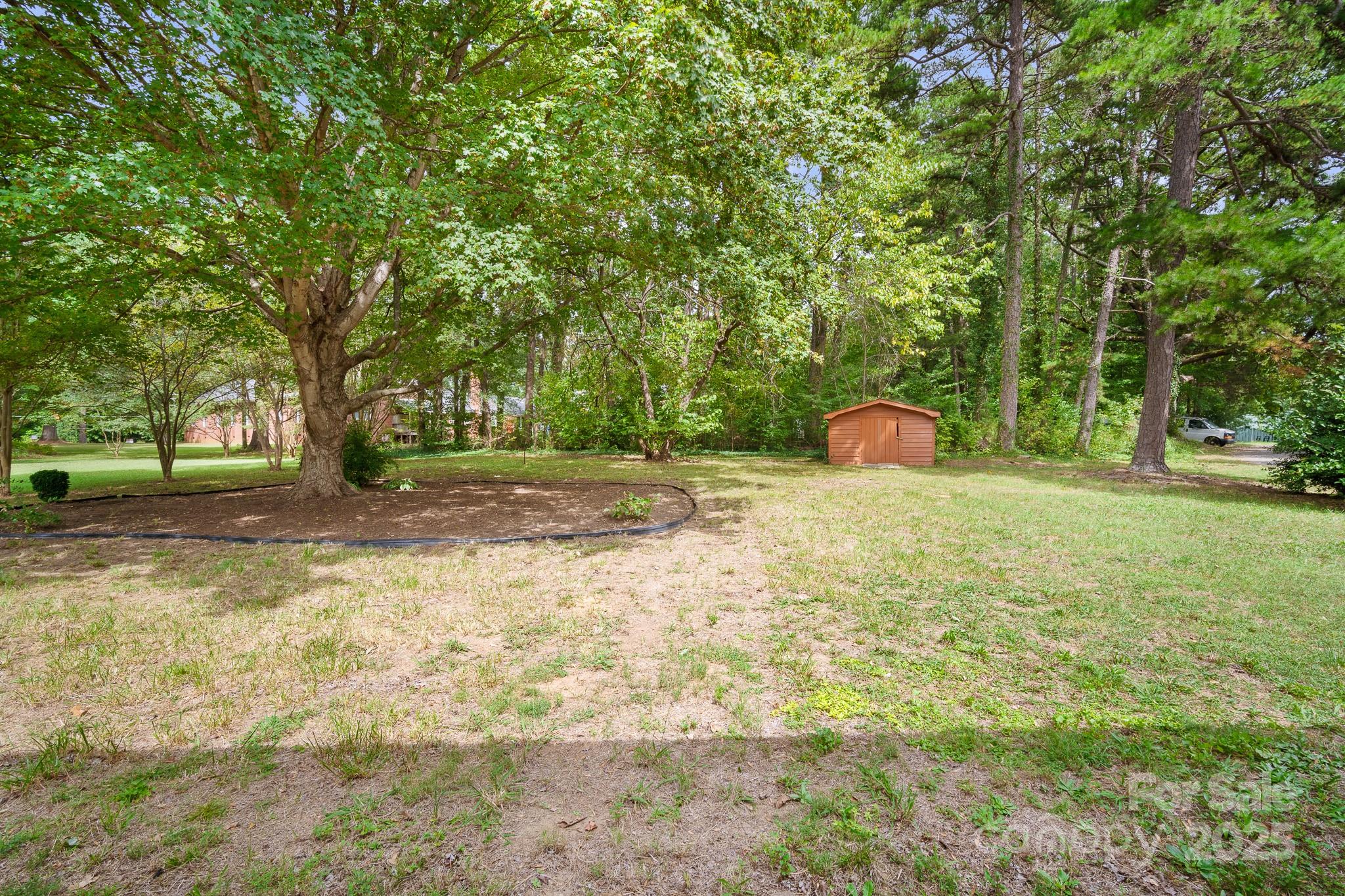 4355 Franklin Community Center Road Salisbury, NC 28144 - Photo 26 of 28 a backyard of a house with lots of green space and fountain