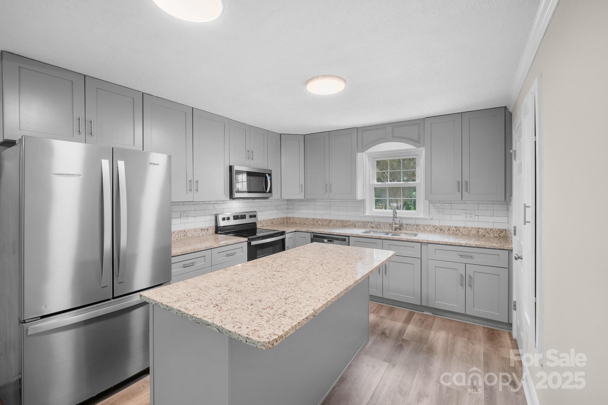 4355 Franklin Community Center Road Salisbury, NC 28144 - Photo 6 of 28 a kitchen with a refrigerator a sink and dishwasher a oven with wooden floor