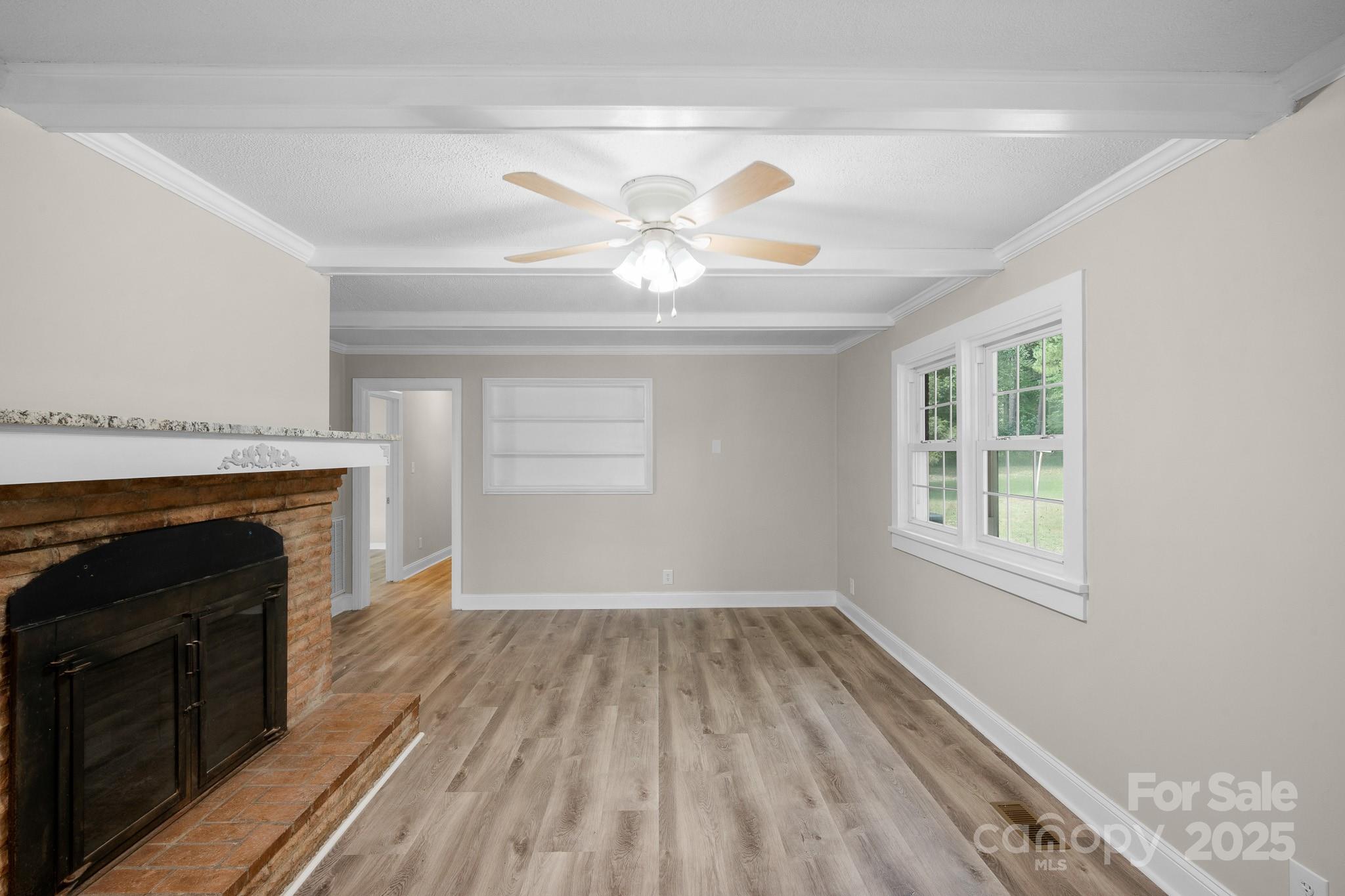 4355 Franklin Community Center Road Salisbury, NC 28144 - Photo 8 of 28 a view of empty room with wooden floor and fireplace