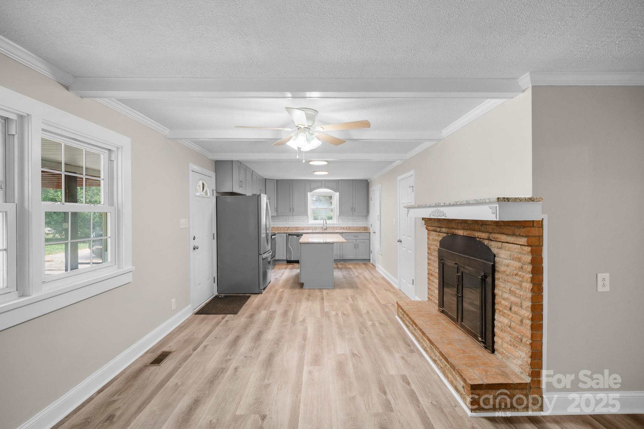 4355 Franklin Community Center Road Salisbury, NC 28144 - Photo 9 of 28 a view of a living room with a fireplace and chandelier