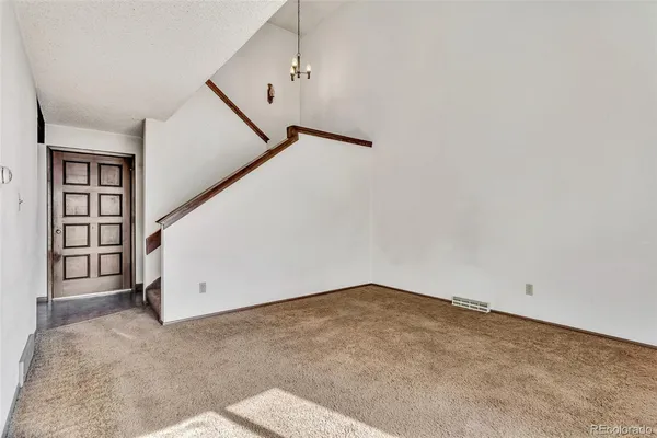 a view of an empty room with stairs