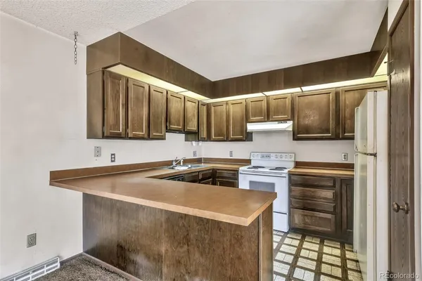 a kitchen that has a sink and a stove in it