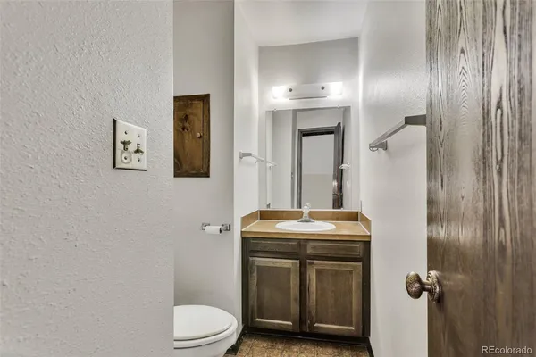 a bathroom with a toilet sink and mirror