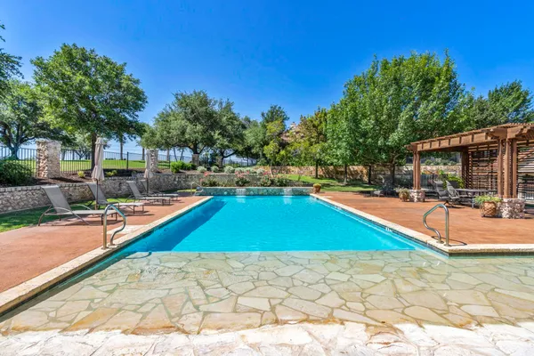 a swimming pool with outdoor seating and yard