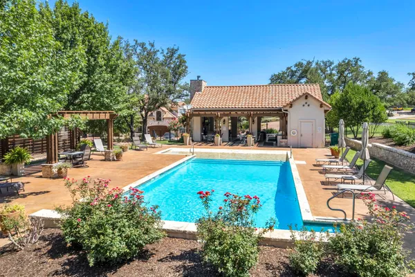 a view of a swimming pool with sitting area