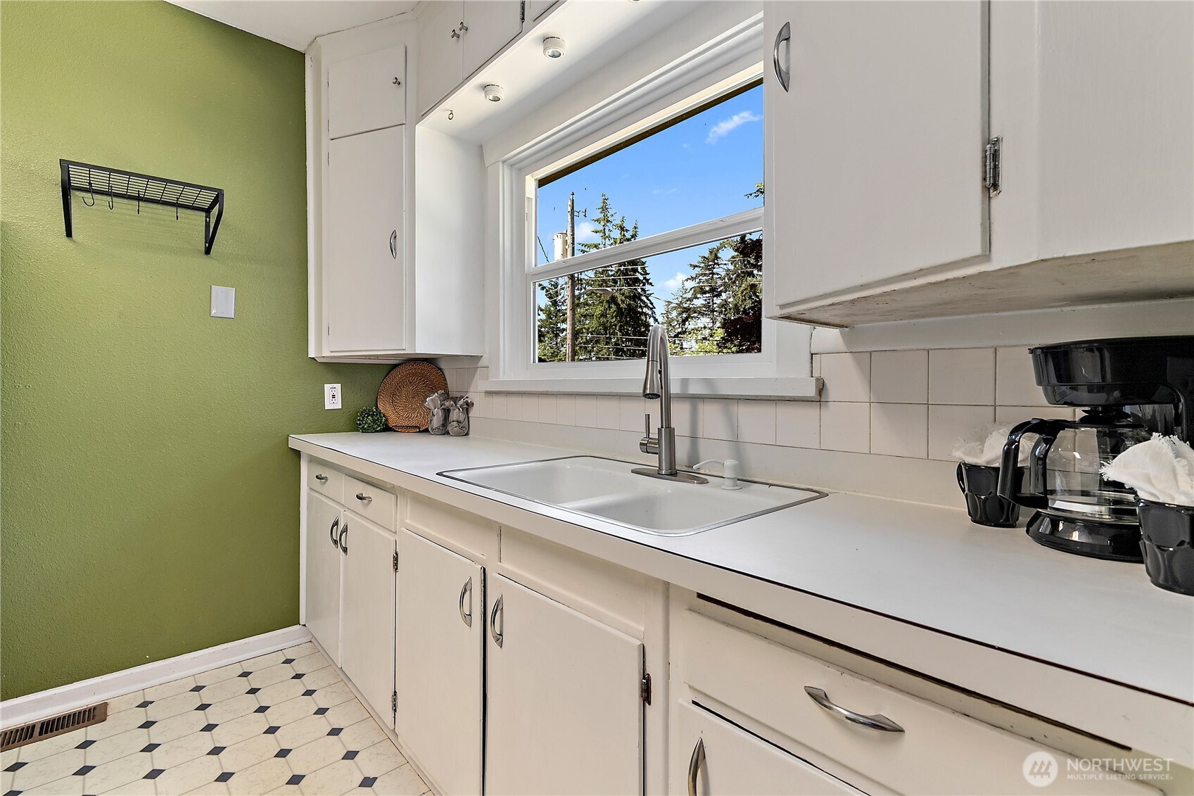 9880 Fredrickson Road Northwest Bremerton, WA 98311 - Photo 10 of 28 a kitchen with a sink and cabinets