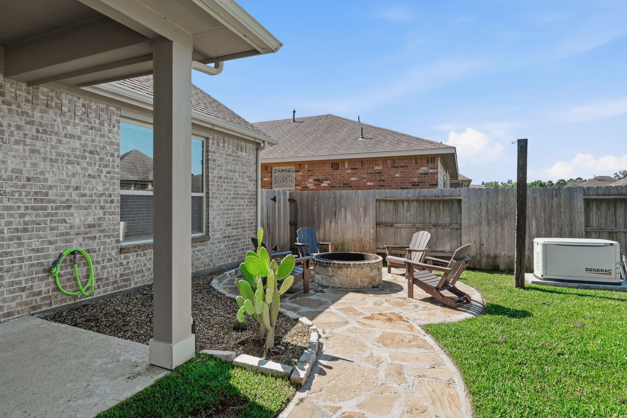 4334 Umber Shadow Drive Spring, TX 77386 - Photo 35 of 45 Backyard includes a landscaped side yard with stone pathways, decorative rock beds, and low-maintenance outdoor spaces.