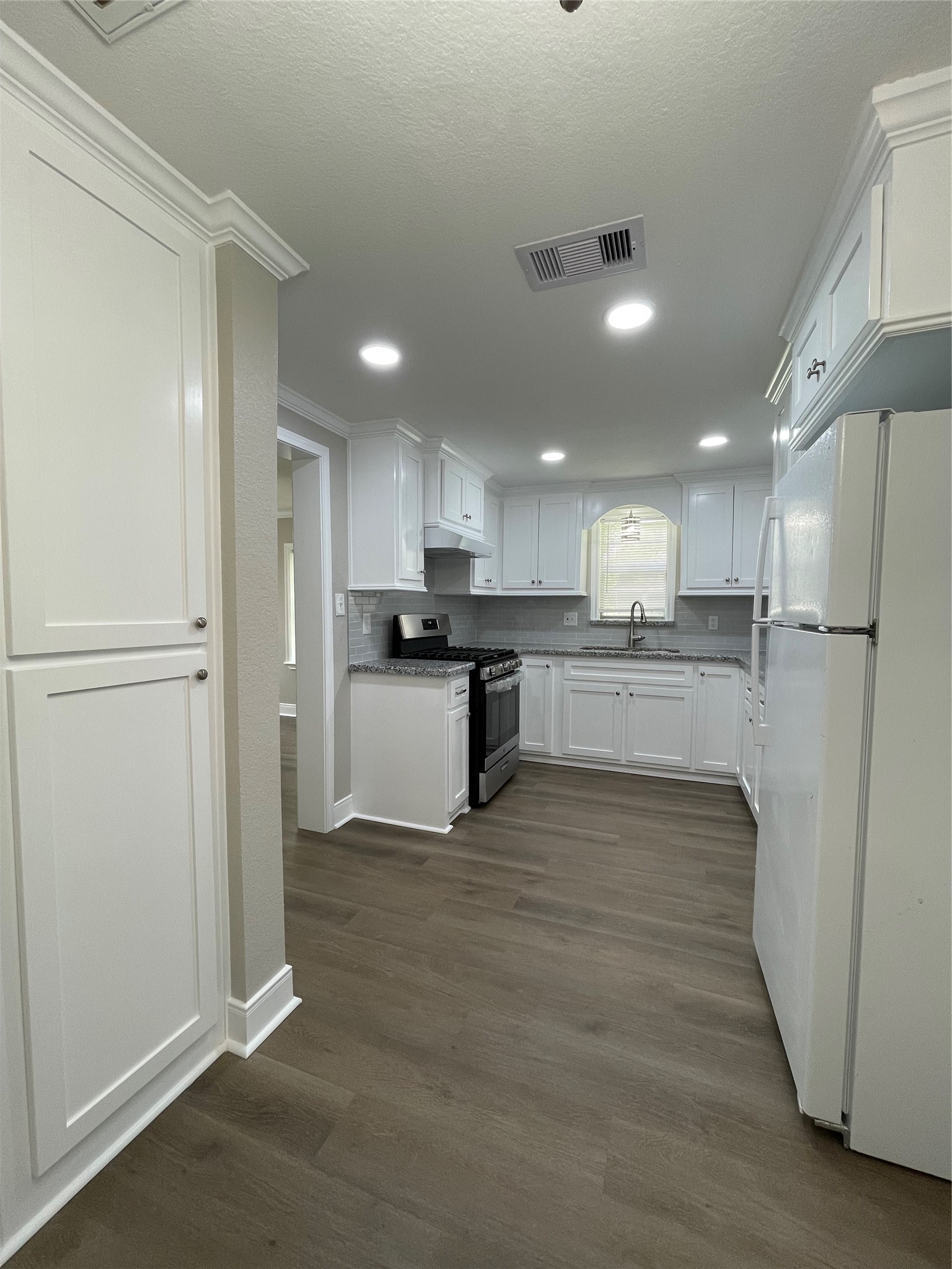 309 Ryan Street Angleton, TX 77515 - Photo 13 of 28 a view of kitchen with wooden floor