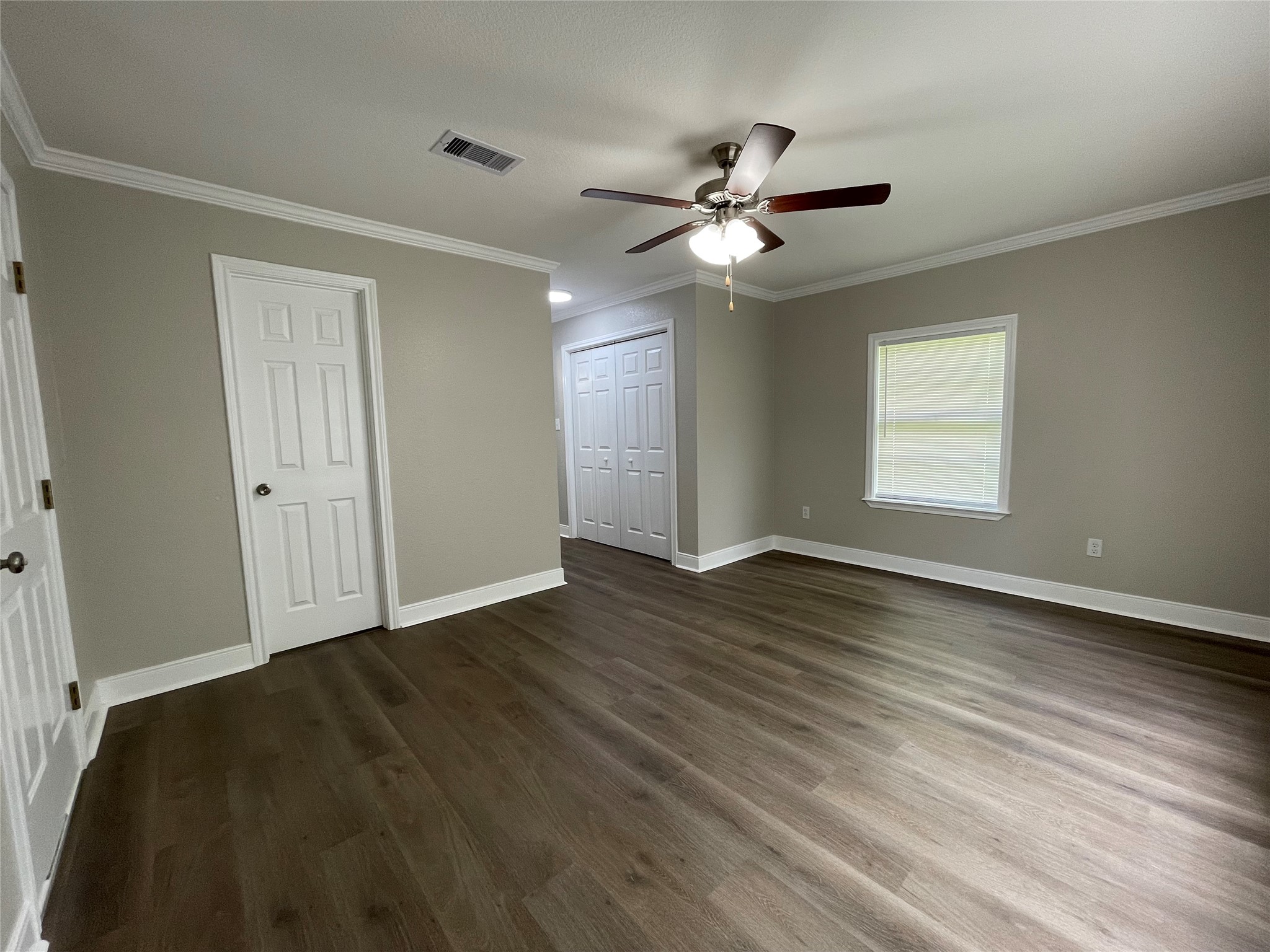 309 Ryan Street Angleton, TX 77515 - Photo 17 of 28 a view of an empty room with wooden floor and a window