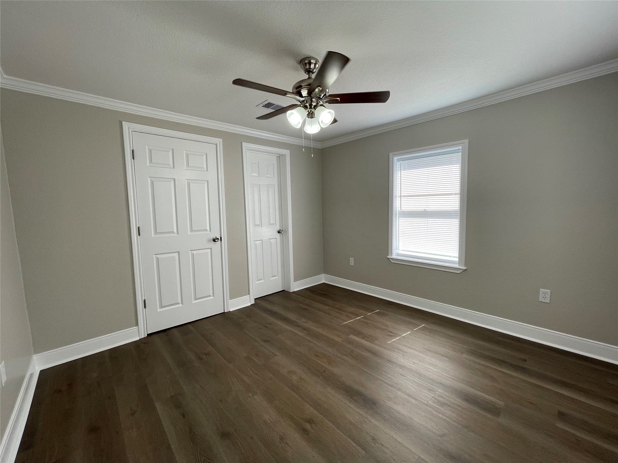 309 Ryan Street Angleton, TX 77515 - Photo 18 of 28 wooden floor in an empty room with a window