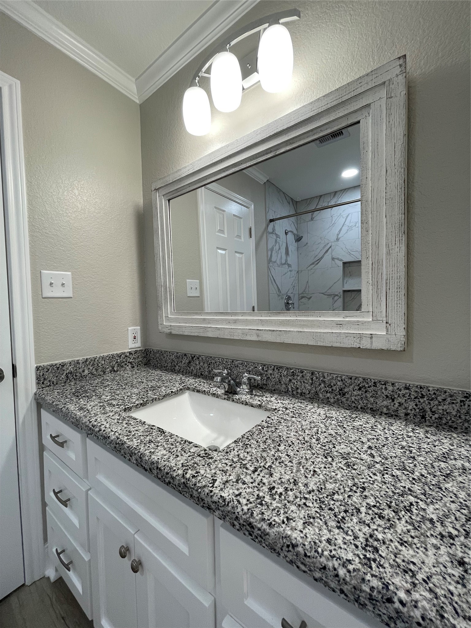 309 Ryan Street Angleton, TX 77515 - Photo 19 of 28 a bathroom with a granite countertop sink and a mirror