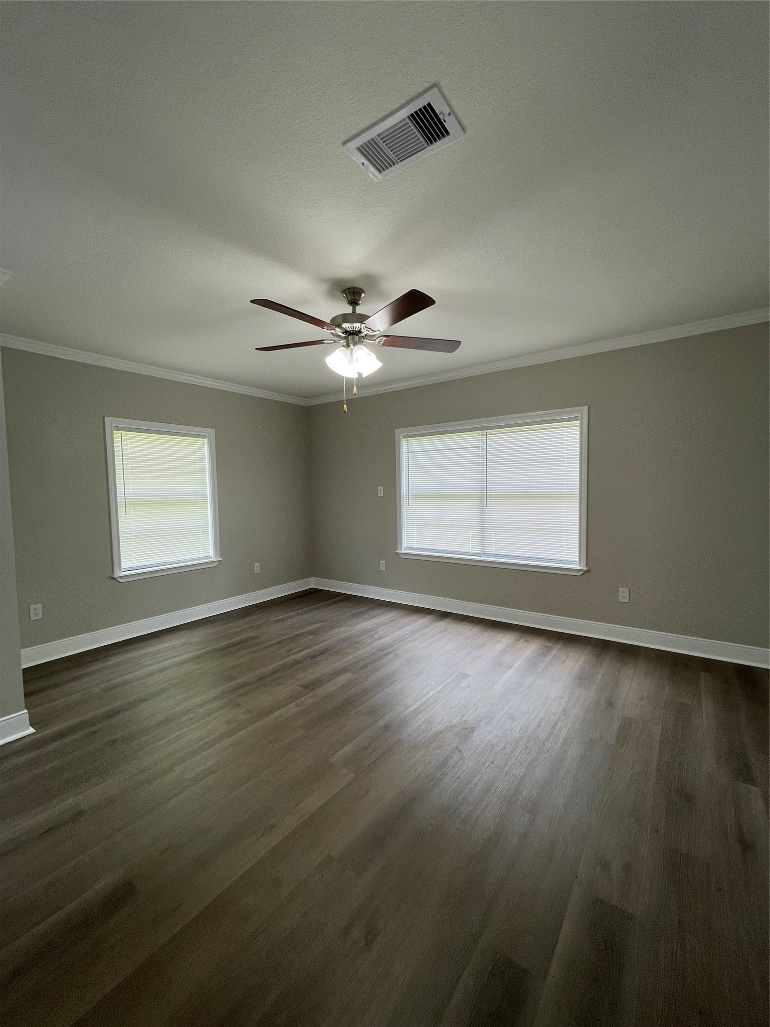 309 Ryan Street Angleton, TX 77515 - Photo 7 of 28 a view of an empty room with wooden floor and a window