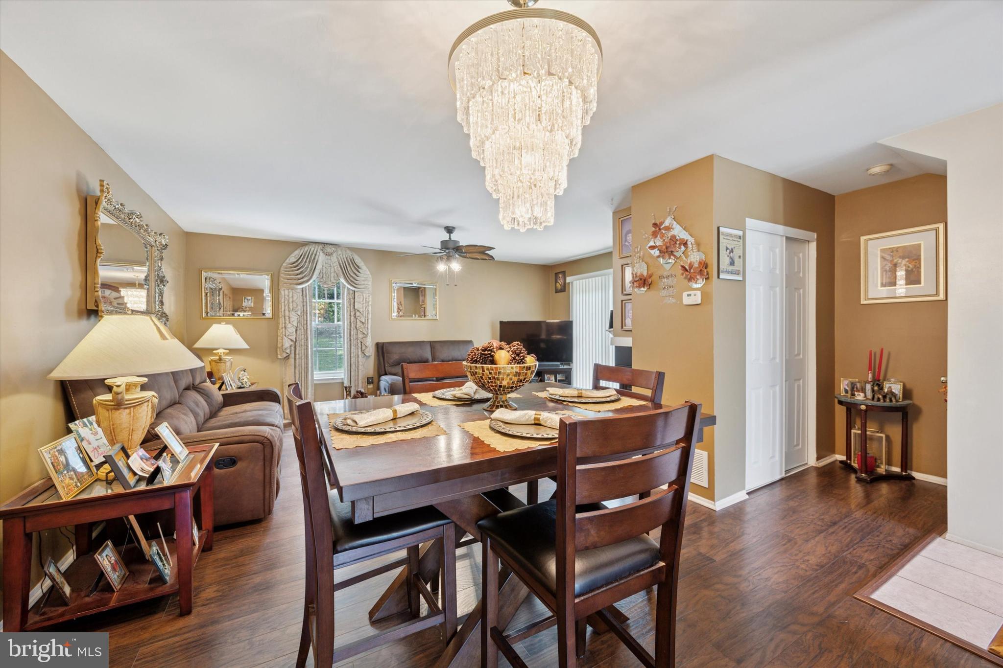 27 Iris Lane Newark, DE 19702 - Photo 11 of 31 a dining room with wooden floor a chandelier a wooden table and chairs