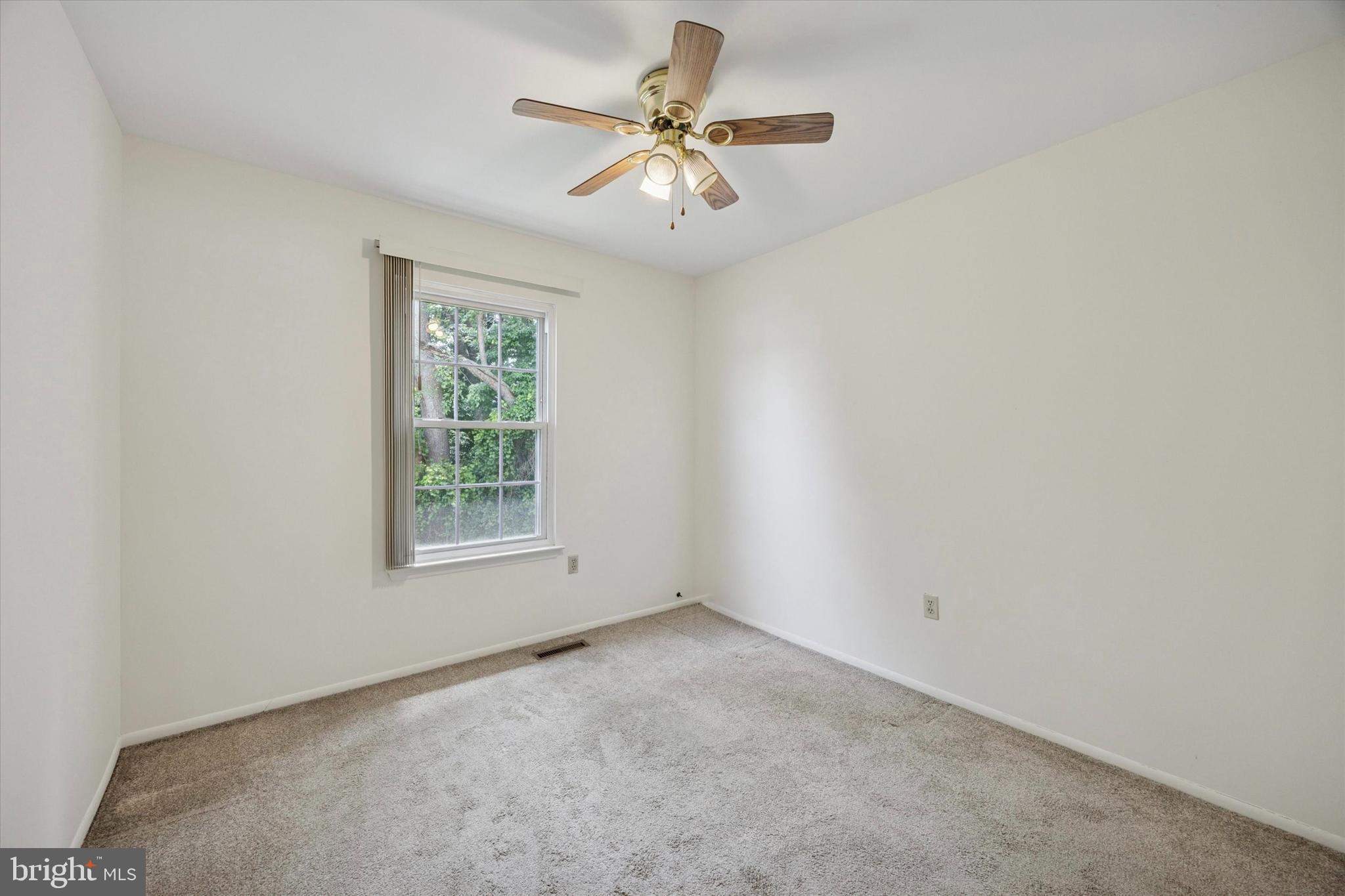 27 Iris Lane Newark, DE 19702 - Photo 22 of 31 an empty room with a window and a ceiling fan