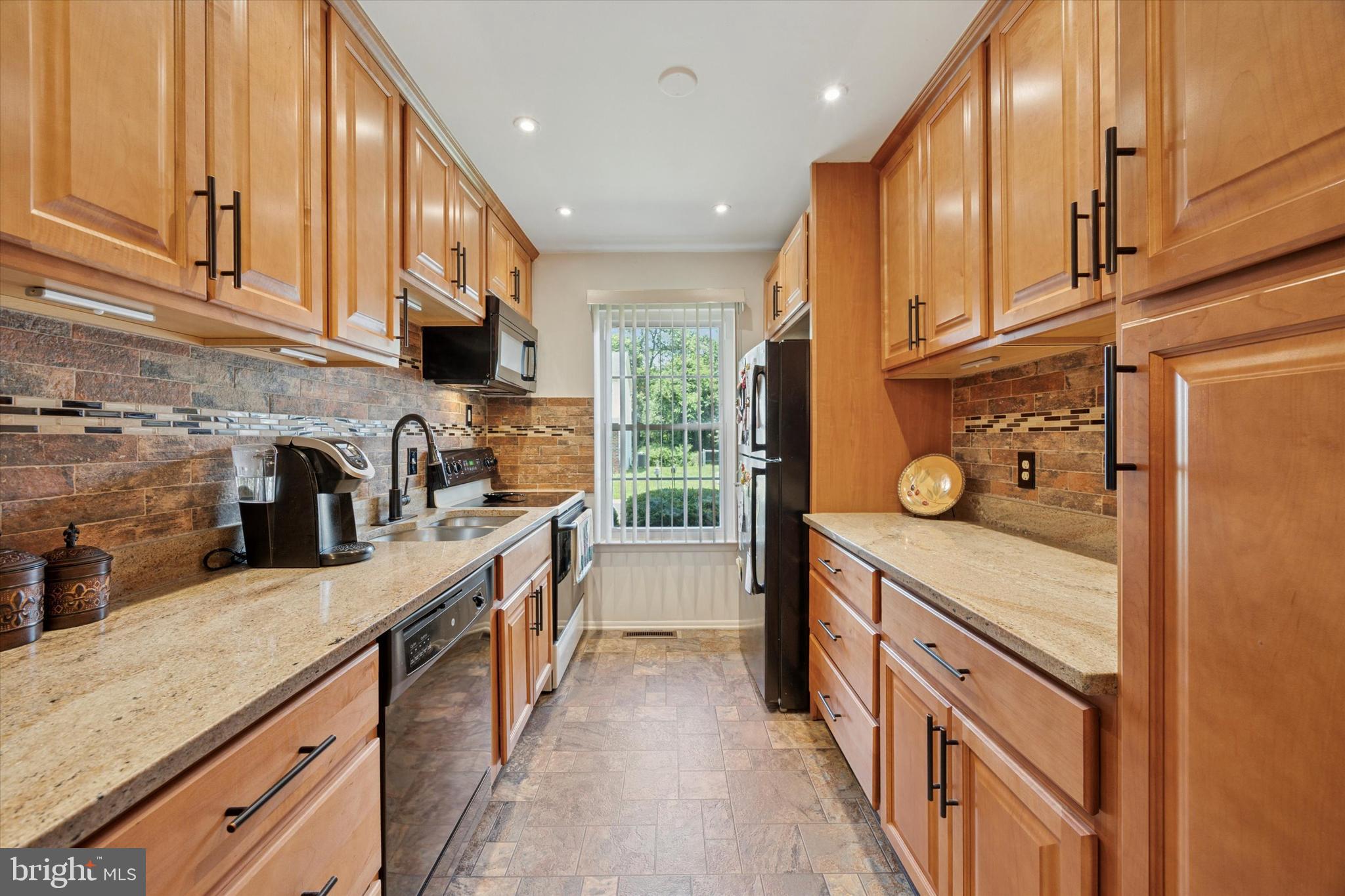 27 Iris Lane Newark, DE 19702 - Photo 9 of 31 a kitchen with stainless steel appliances granite countertop lots of counter top space and wooden floor