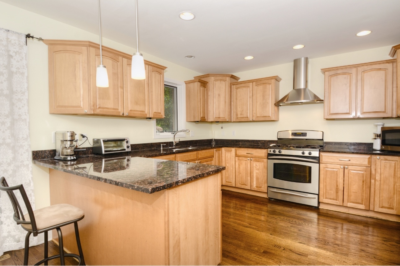 1115 Harms Road Glenview, IL 60025 - Photo 14 of 34 a kitchen with stainless steel appliances granite countertop a sink stove and refrigerator