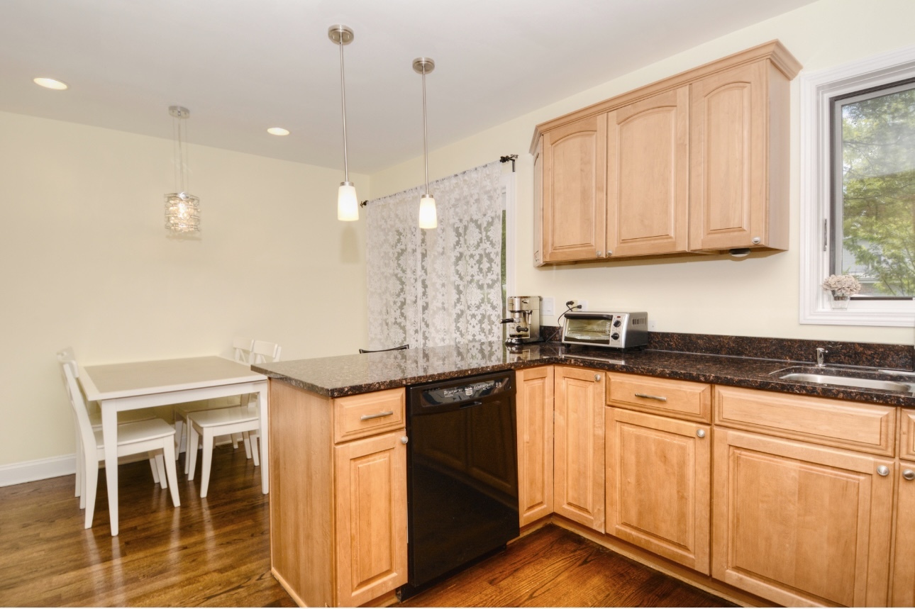 1115 Harms Road Glenview, IL 60025 - Photo 15 of 34 a kitchen with granite countertop sink stove and cabinets