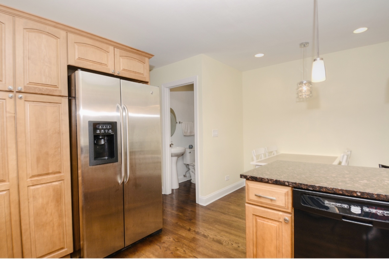 1115 Harms Road Glenview, IL 60025 - Photo 16 of 34 a kitchen with stainless steel appliances granite countertop a refrigerator and a sink