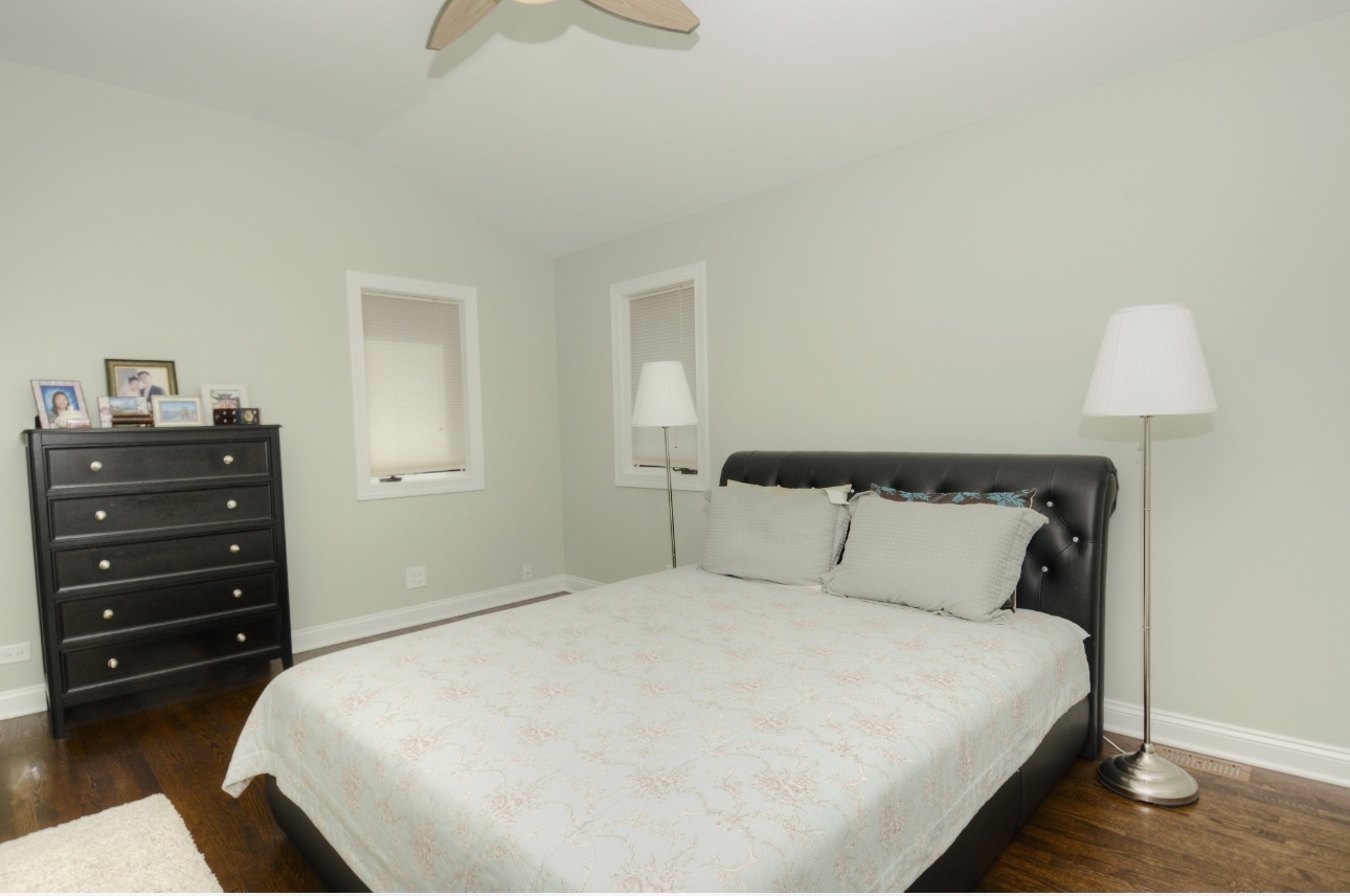 1115 Harms Road Glenview, IL 60025 - Photo 18 of 34 a bedroom with a bed and a night stand