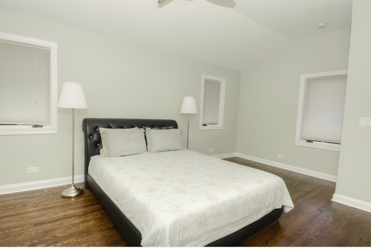 1115 Harms Road Glenview, IL 60025 - Photo 19 of 34 a large bed sitting in a bedroom next to a window