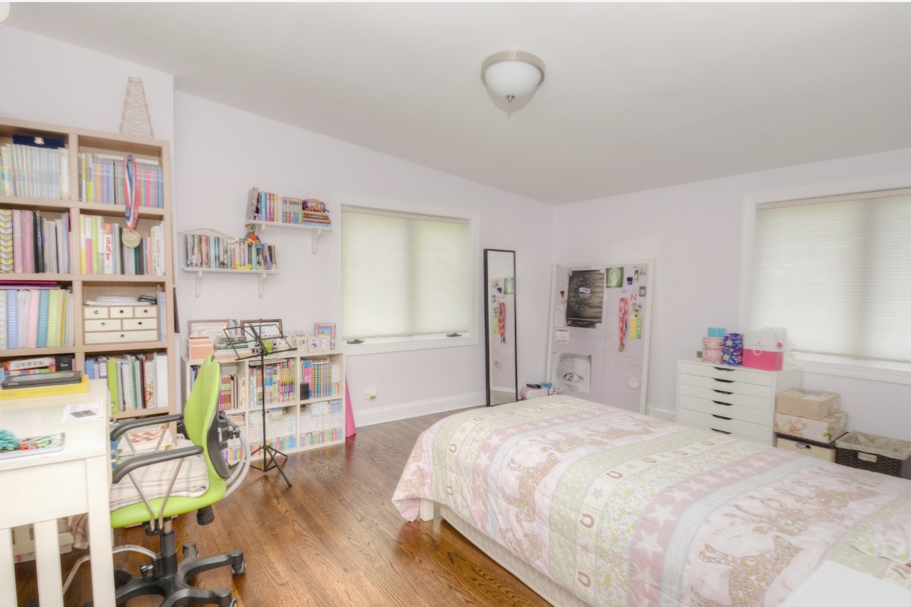 1115 Harms Road Glenview, IL 60025 - Photo 20 of 34 a bedroom with a bed and a book shelf