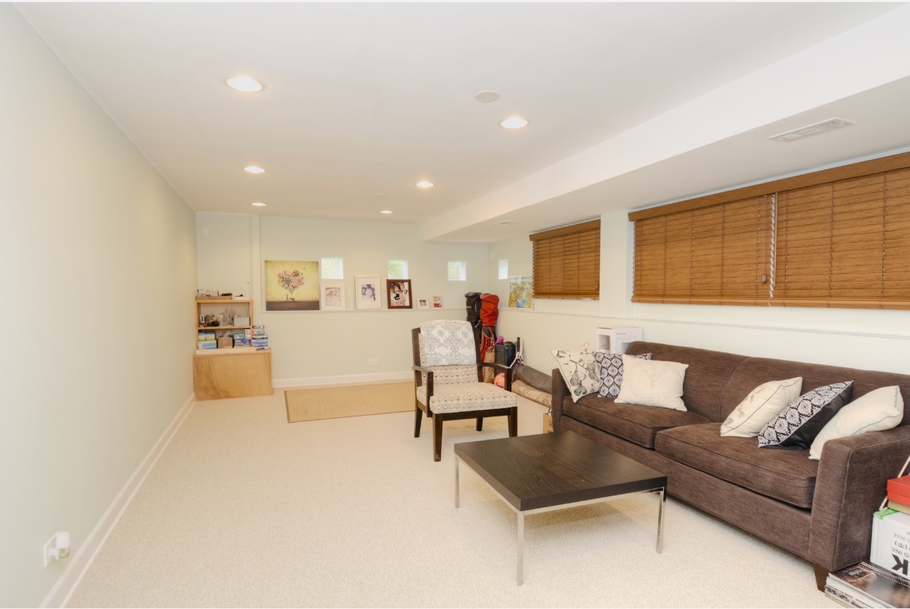 1115 Harms Road Glenview, IL 60025 - Photo 23 of 34 a living room with furniture and a flat screen tv