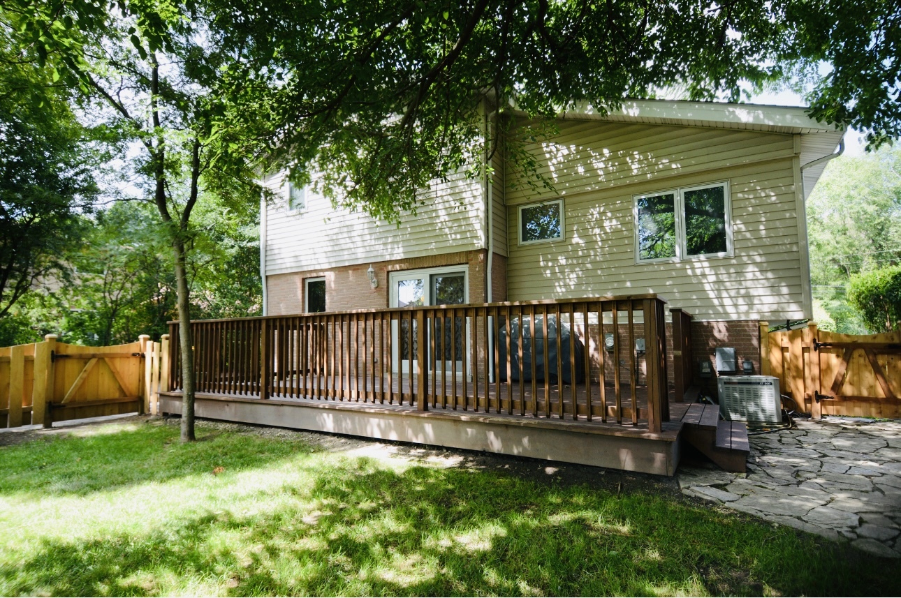 1115 Harms Road Glenview, IL 60025 - Photo 29 of 34 a view of backyard with deck and a large tree