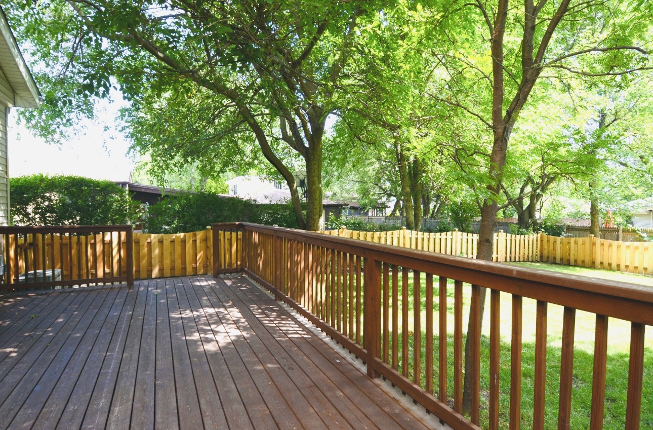 1115 Harms Road Glenview, IL 60025 - Photo 30 of 34 a view of balcony with wooden floor and fence