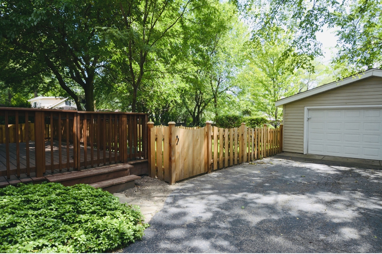 1115 Harms Road Glenview, IL 60025 - Photo 31 of 34 a view of backyard with wooden fence and large trees