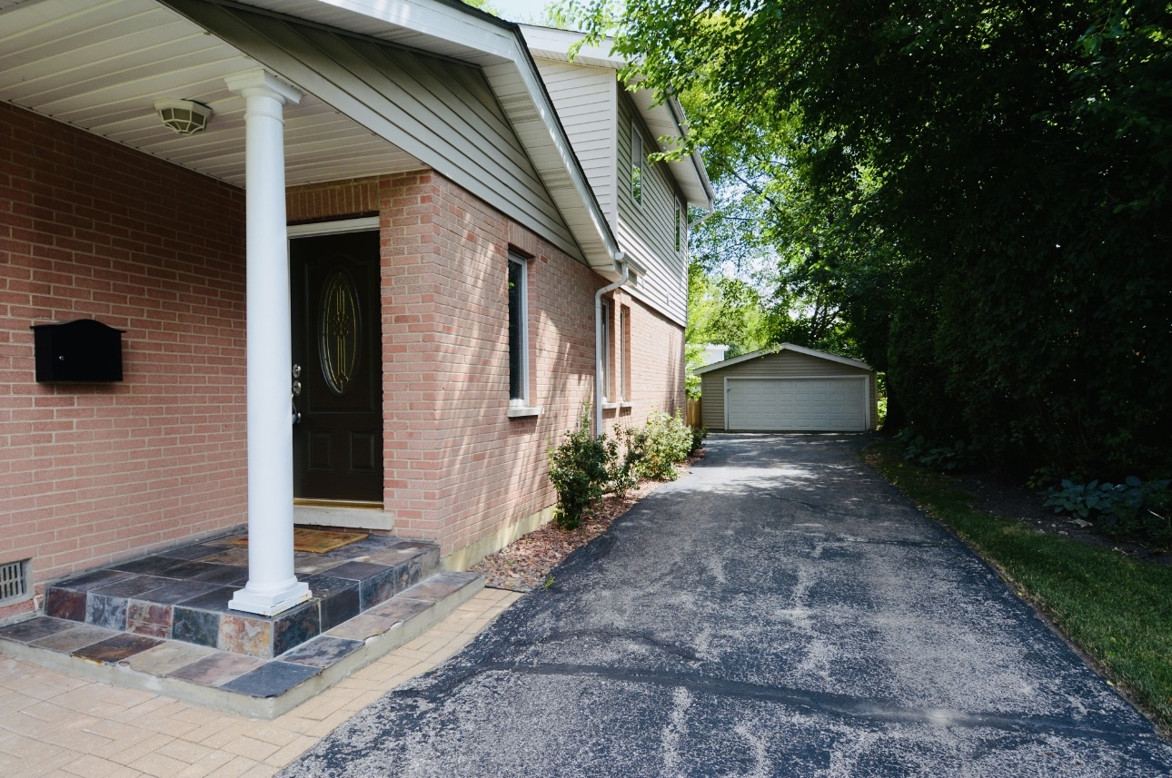 1115 Harms Road Glenview, IL 60025 - Photo 4 of 34 a front view of a house with garden