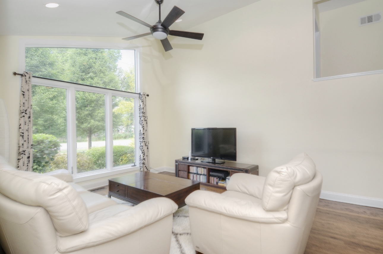 1115 Harms Road Glenview, IL 60025 - Photo 7 of 34 a living room with furniture and a flat screen tv