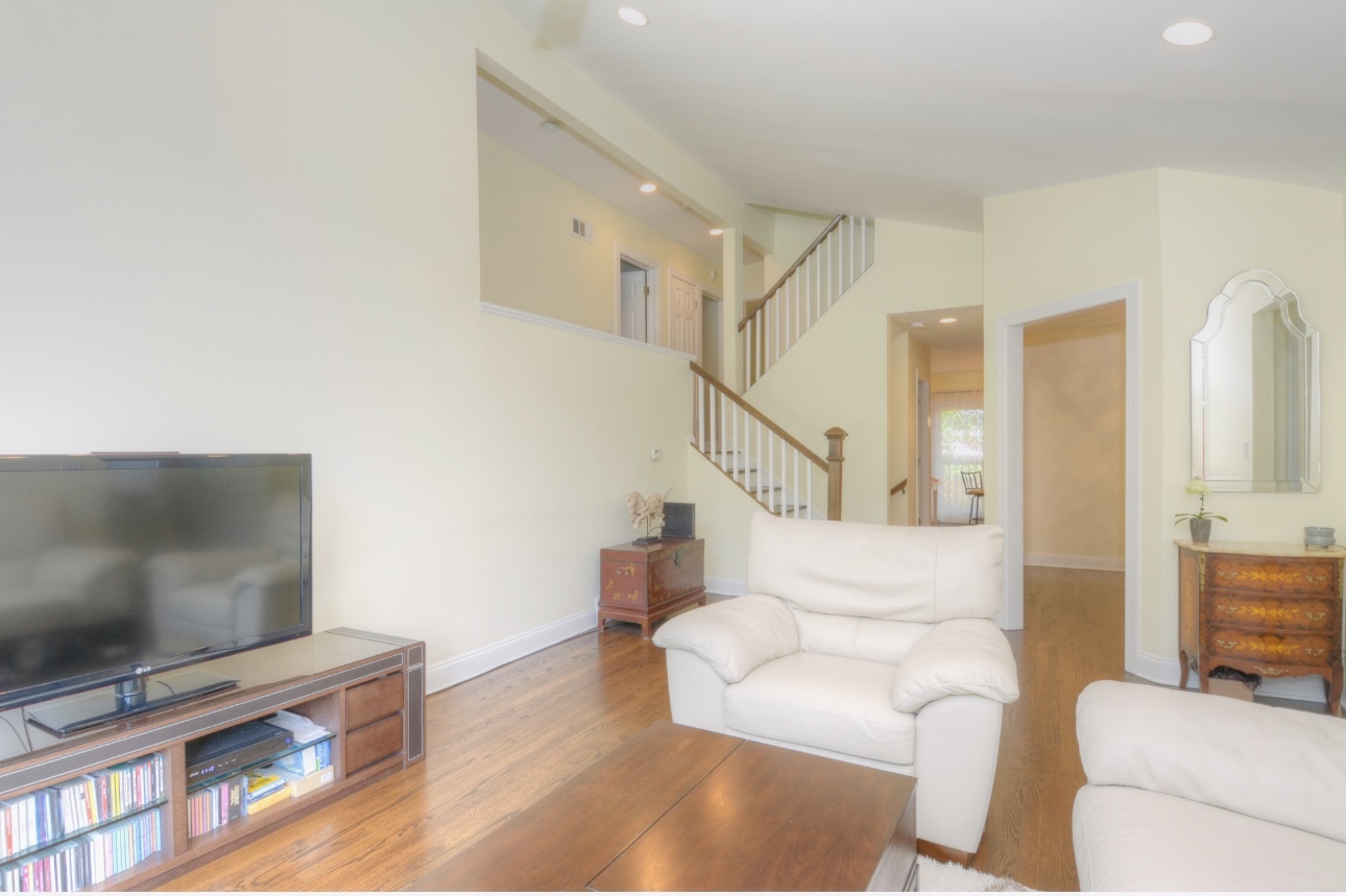 1115 Harms Road Glenview, IL 60025 - Photo 9 of 34 a living room with furniture and a flat screen tv