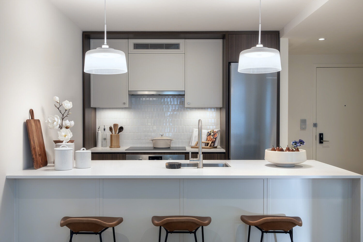 335 8th Avenue, Unit 227 Manhattan, NY 10001 - Photo 2 of 12 a kitchen with stainless steel appliances a table and chairs in it