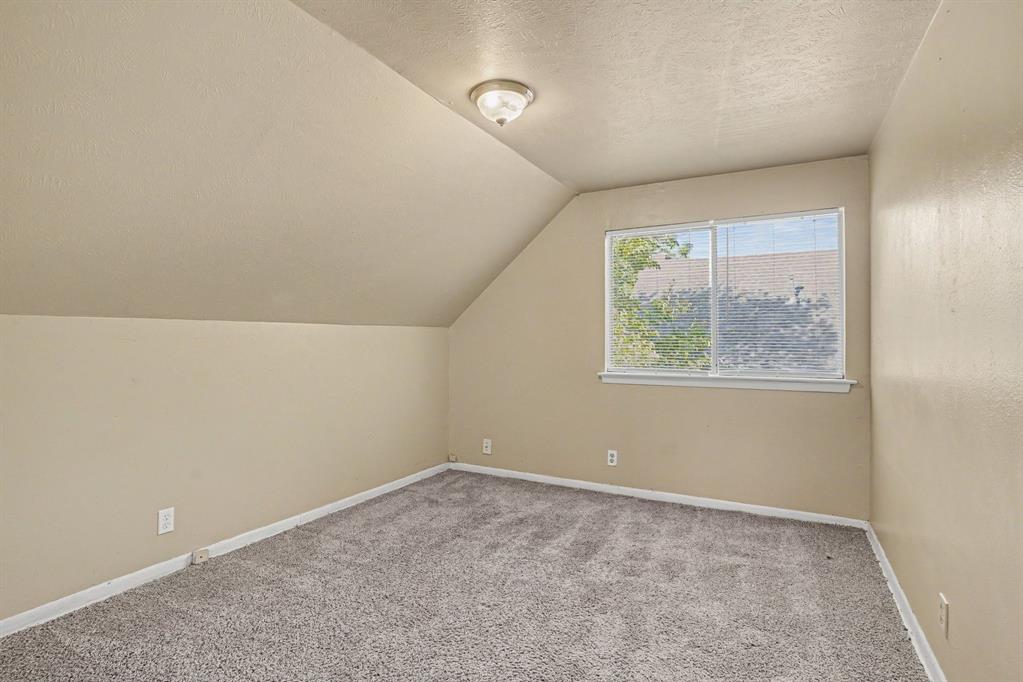 1414 Finley Road Irving, TX 75062 - Photo 19 of 27 Sloped ceiling room featuring carpet flooring and a window with blinds