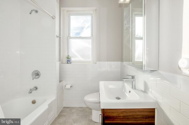a bathroom with a sink a toilet and bathtub