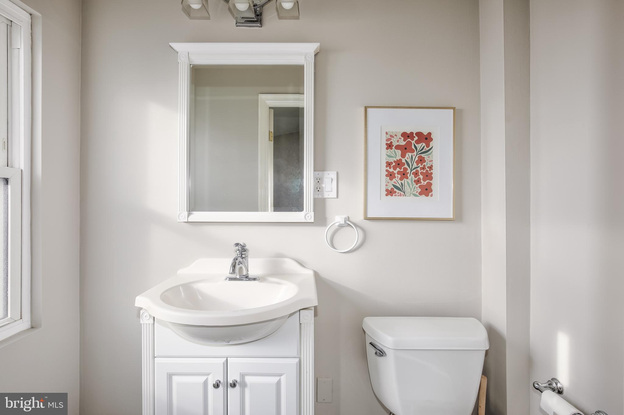 1932 First Street Northeast Washington, DC 20002 - Photo 10 of 21 a bathroom with a toilet a sink and mirror