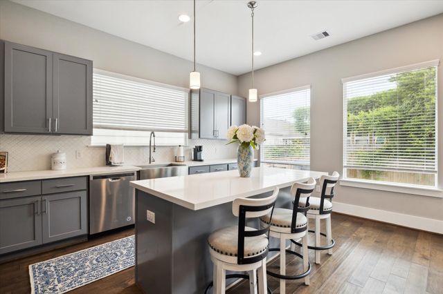 a kitchen with a table chairs stove and microwave